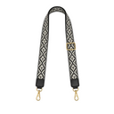 Black and white patterned bag strap with gold hardware on a white background