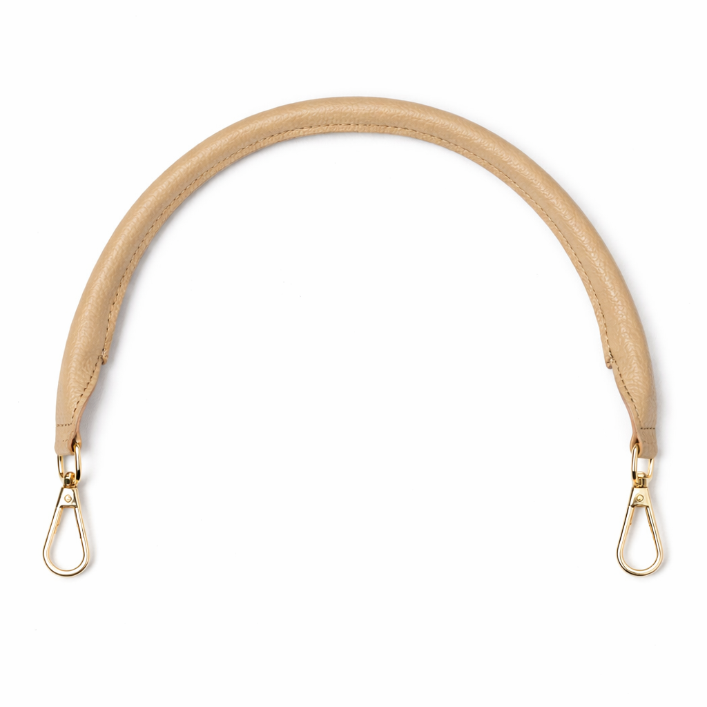 Beige bag strap with metal hooks on a white background