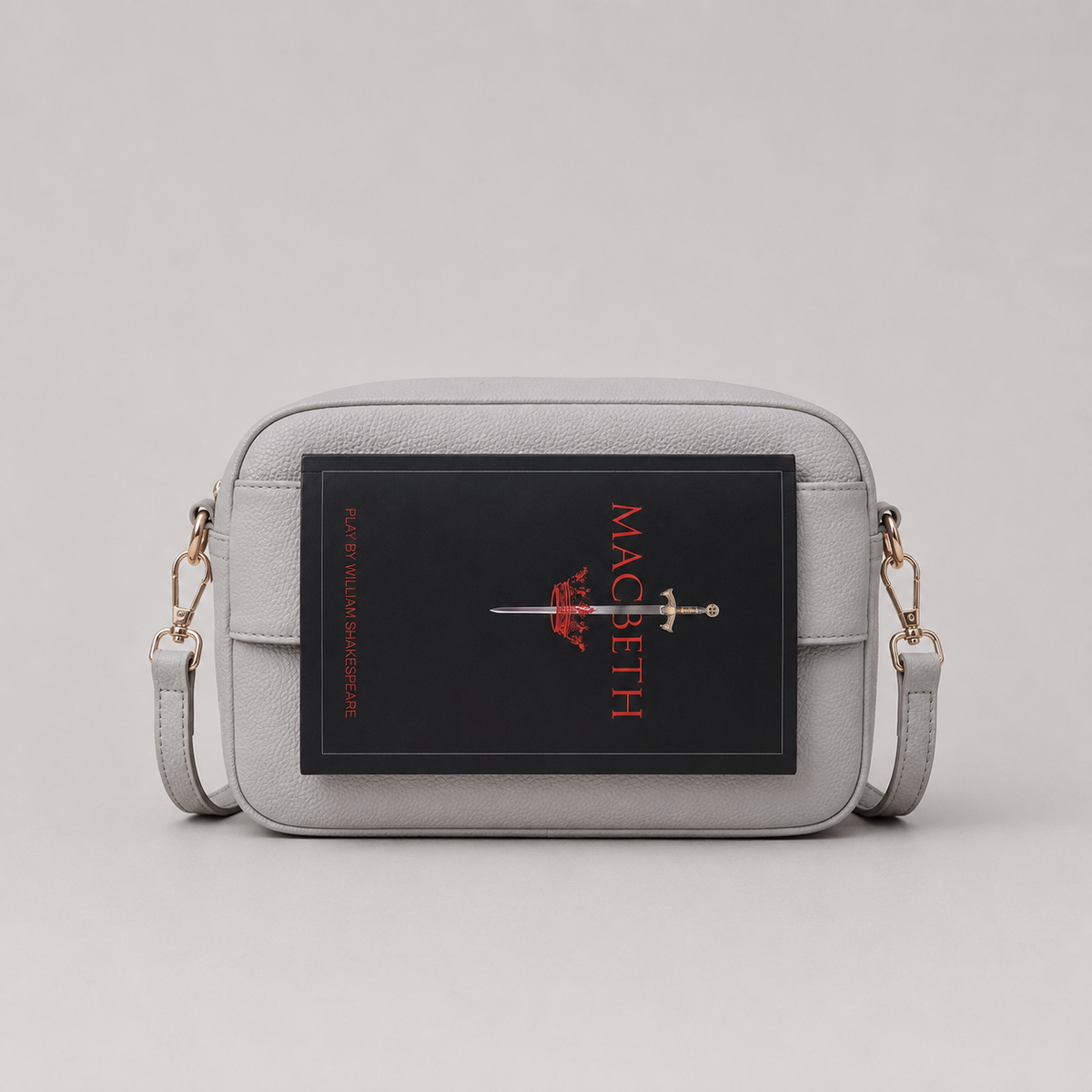 The Daily Stone bookmark-inspired crossbody bag holding a book