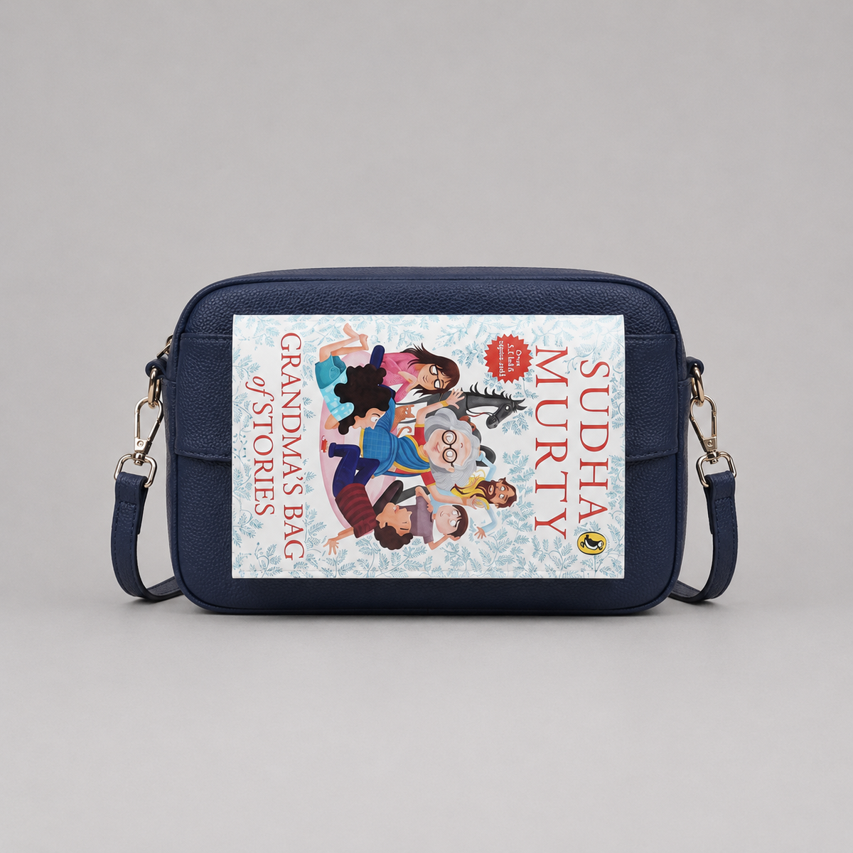 The Daily Navy bookmark-inspired crossbody bag holding a book