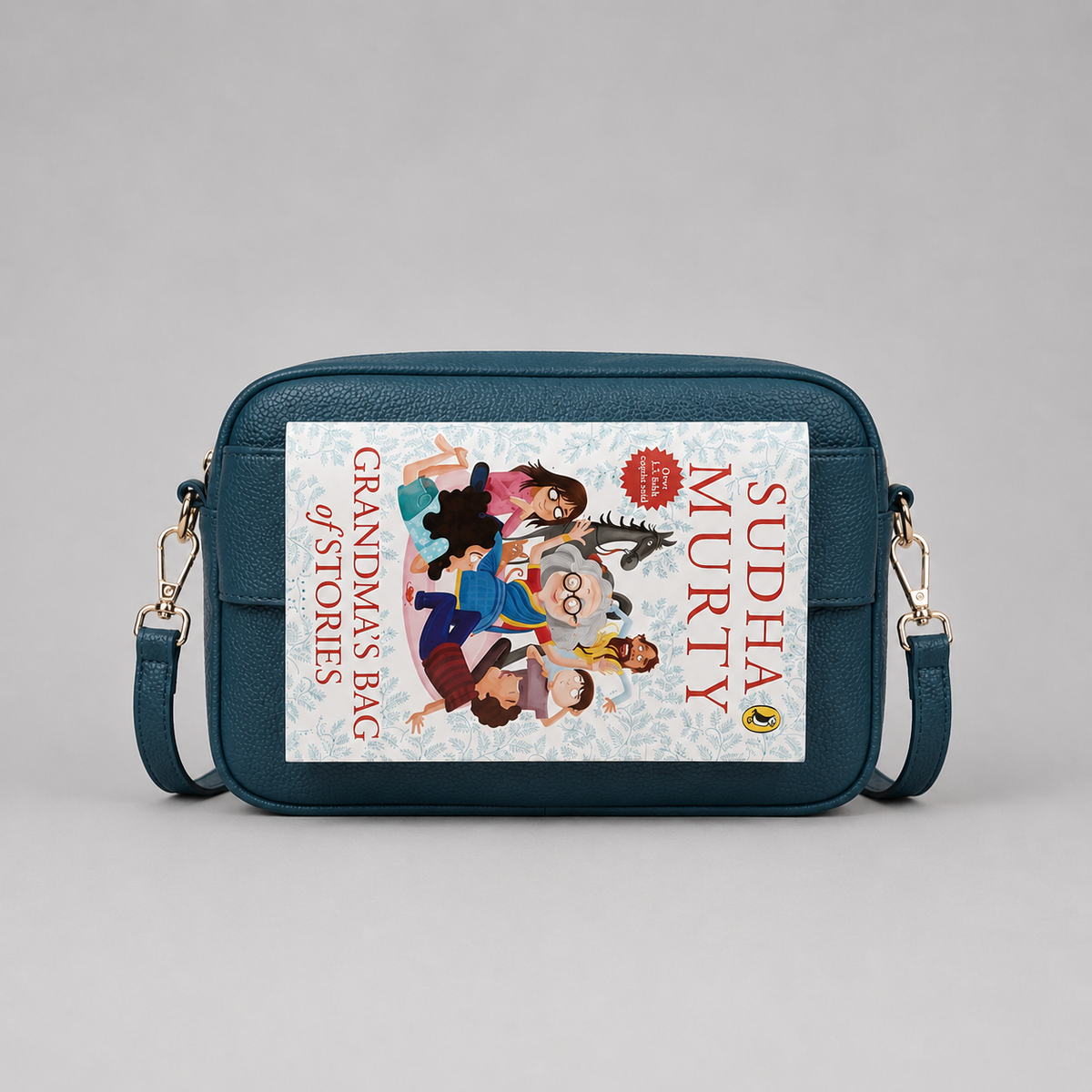 The Daily Teal bookmark-inspired crossbody bag holding a book