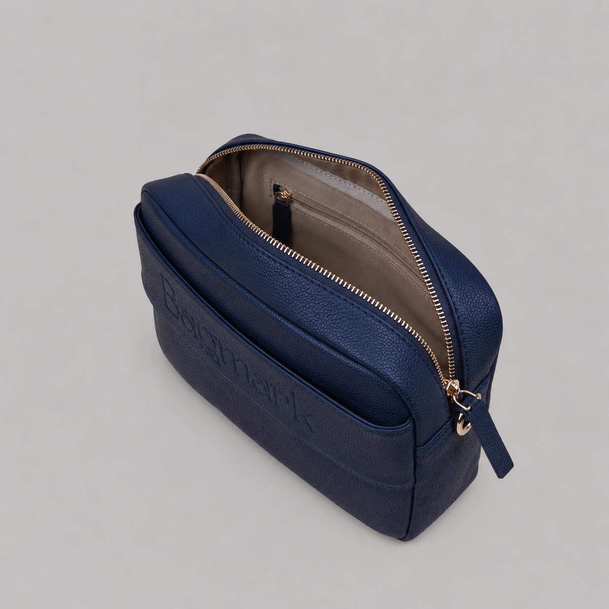 The Daily in Navy bookmark-inspired crossbody bag with gold zipper displaying inner compartments of the bag