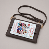 The Essential Taupe Brown bookmark-inspired crossbody bag holding a book