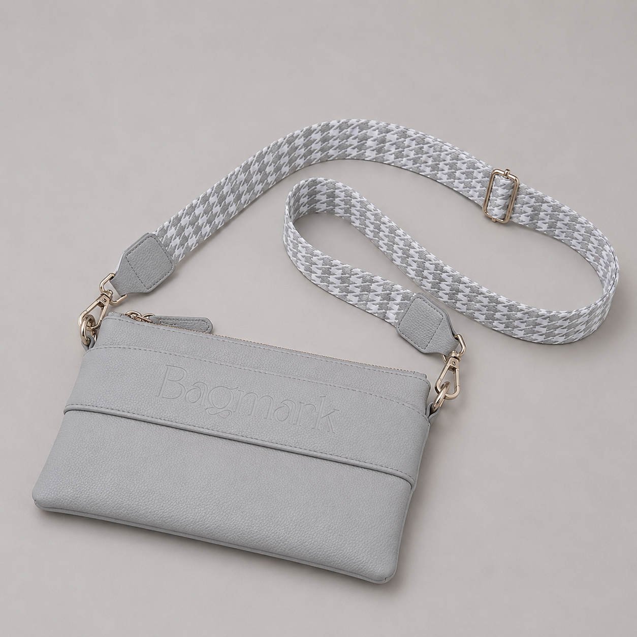 The Essential Stone bookmark crossbody bag with a patterned webbing strap