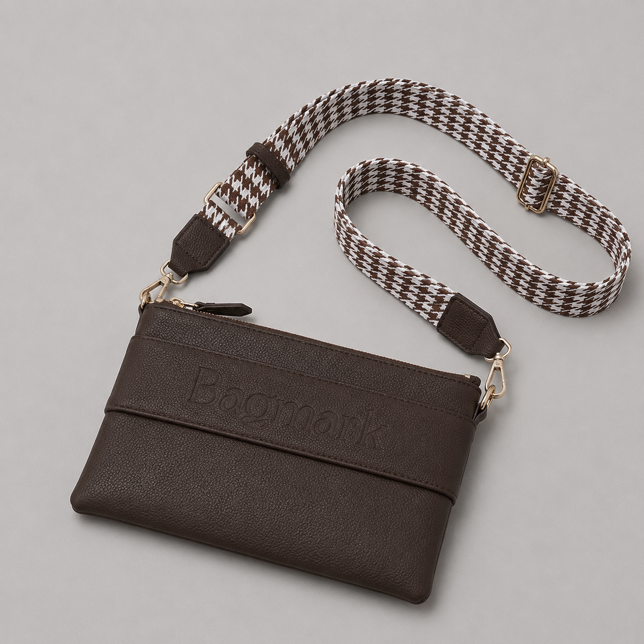 The Essential Taupe Brown bookmark crossbody bag with a patterned webbing strap