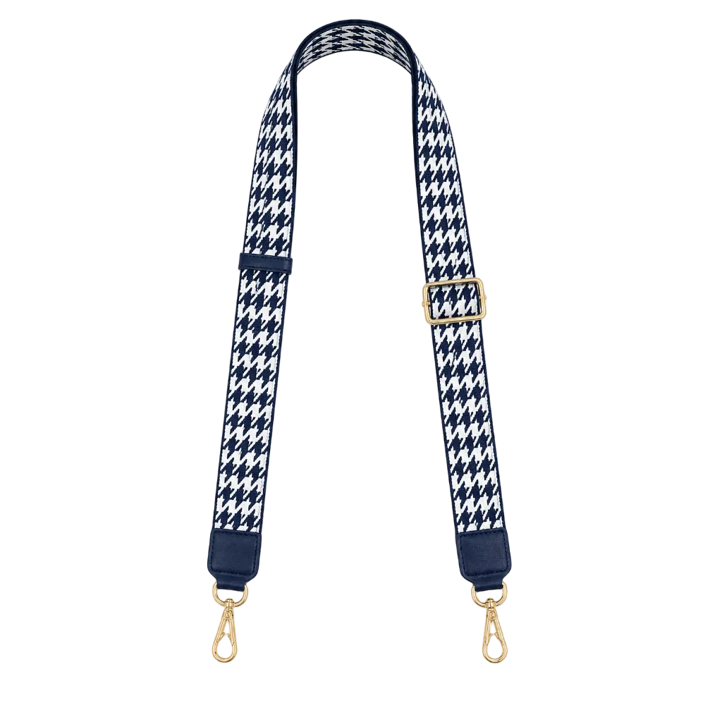 Navy and white houndstooth patterned strap with gold hardware on a white background