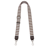 Houndstooth patterned strap with metal hooks on a white background