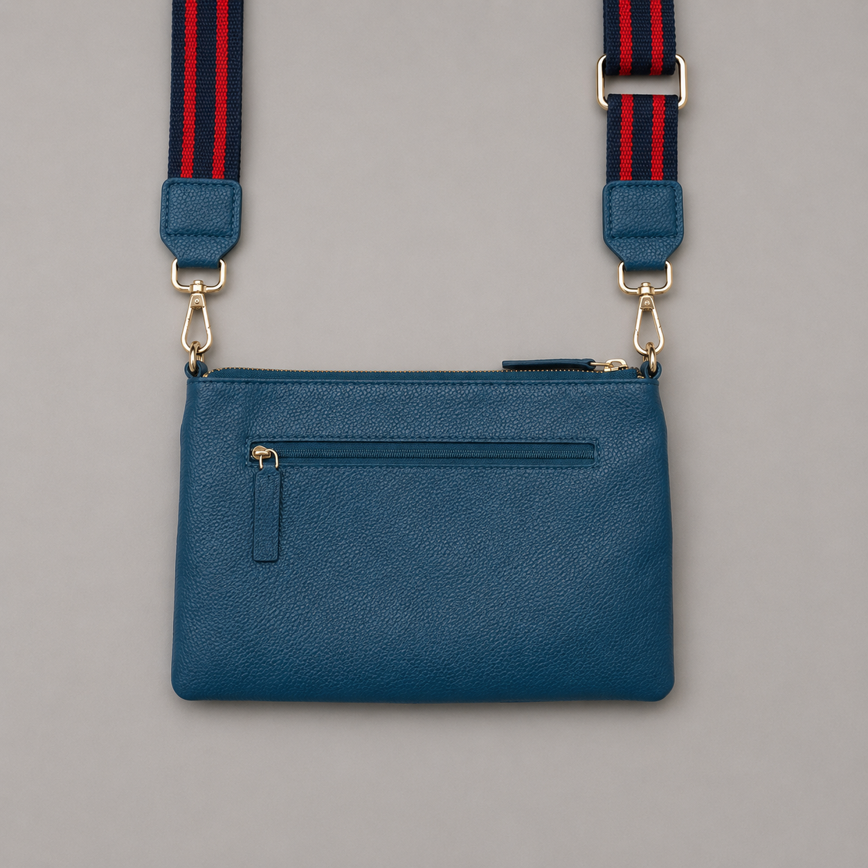 The Essential Teal literary bag displaying back zip pocket