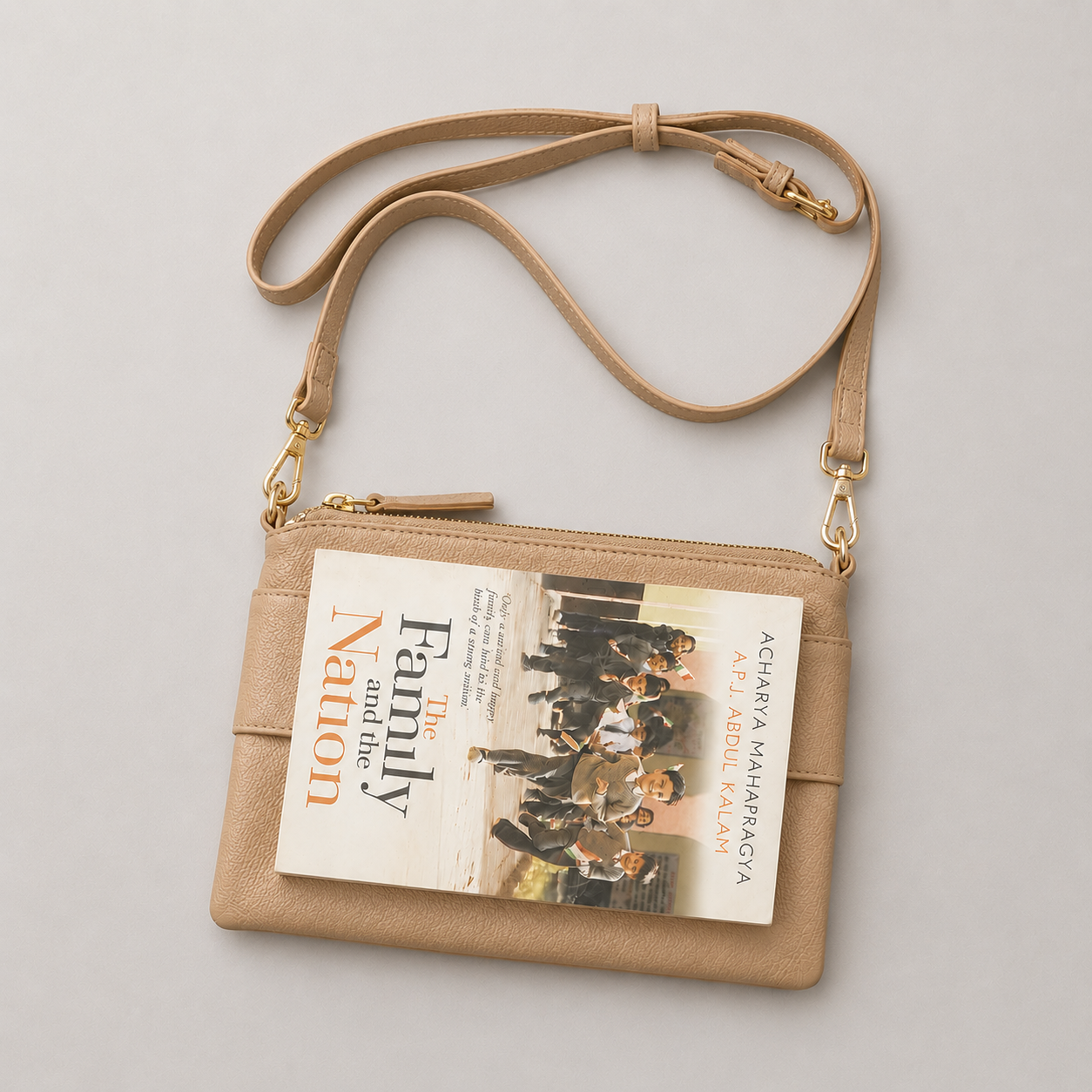 The Essential Camel bookmark-inspired crossbody bag holding a book