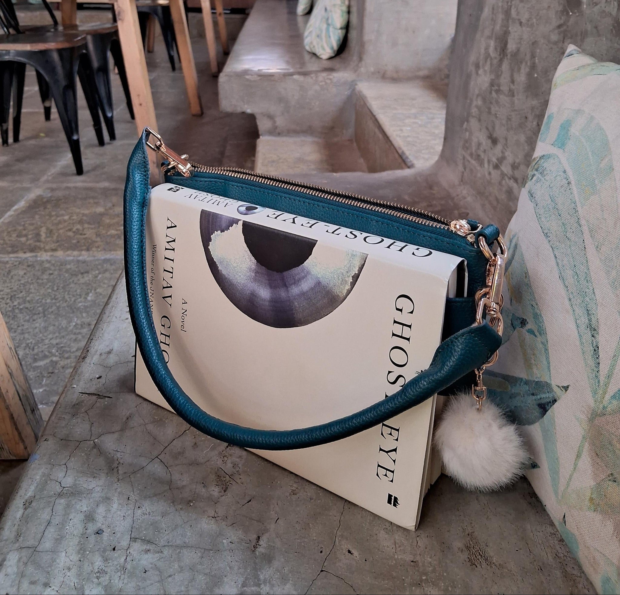 The Essential Teal bookmark bag with book secured in front strap