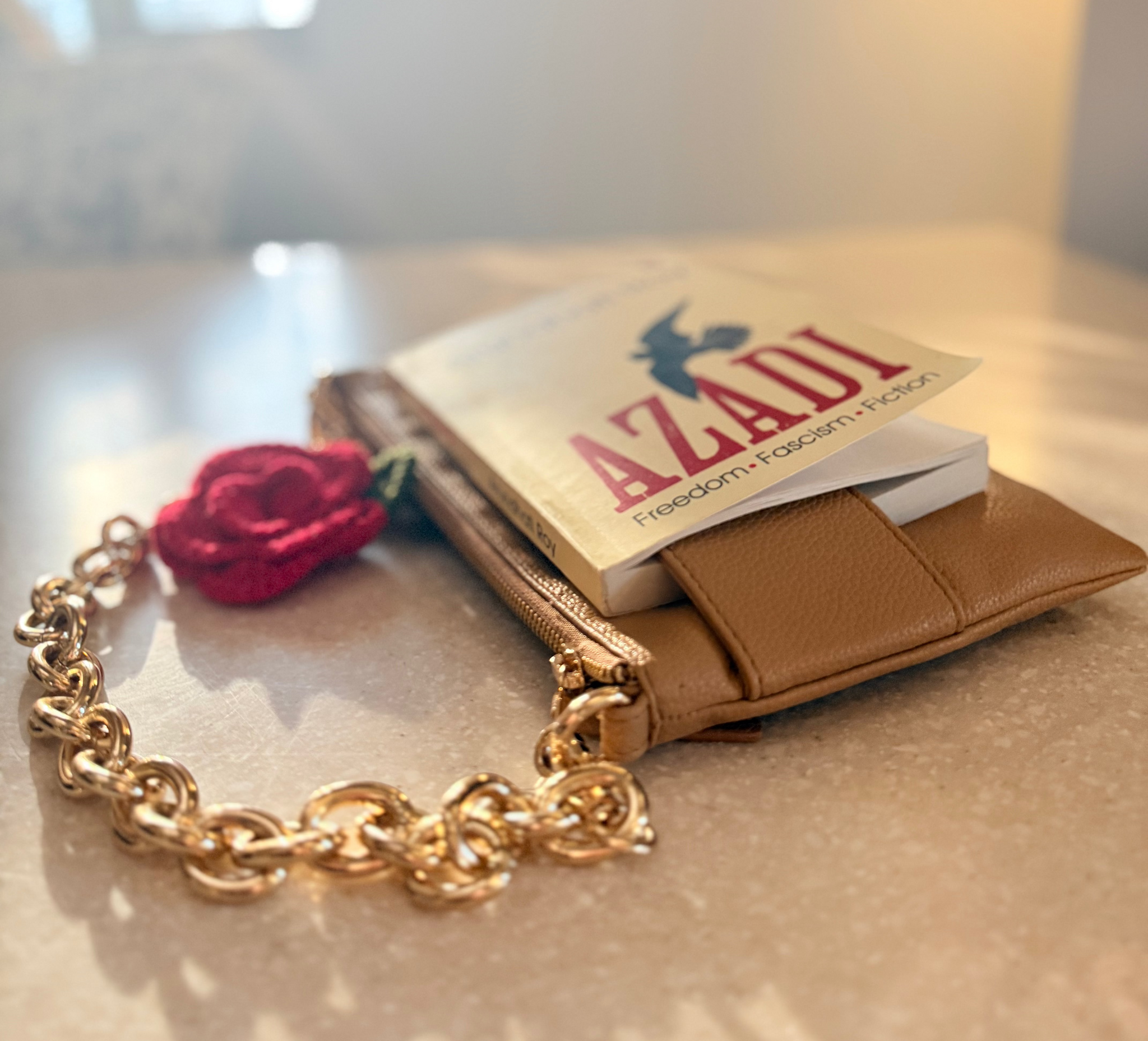 The Essential Camel bookmark bag with book secured in front strap